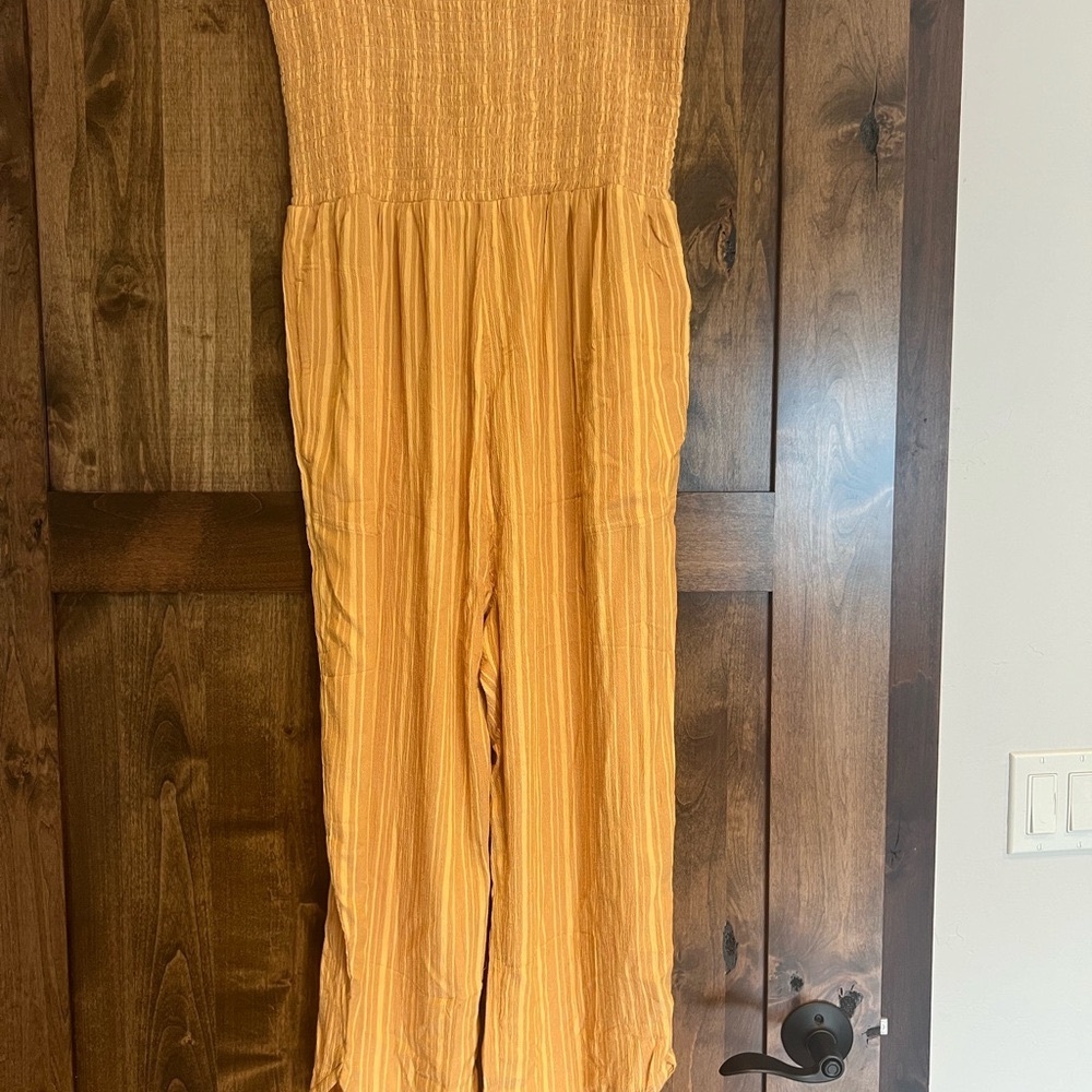 Woman’s Prana Fernie Jumpsuit. Size large. Orange with pockets and  straps.